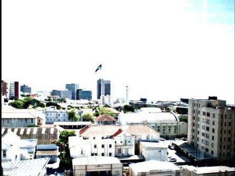 An elevated urban view overlooking surrounding apartment buildings and city infrastructure under a bright sky.