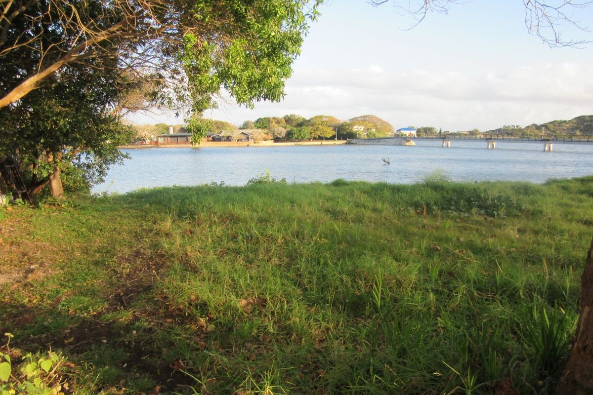 A scenic view of a tranquil lake or lagoon, showcasing the natural waterfront landscape and surrounding greenery.