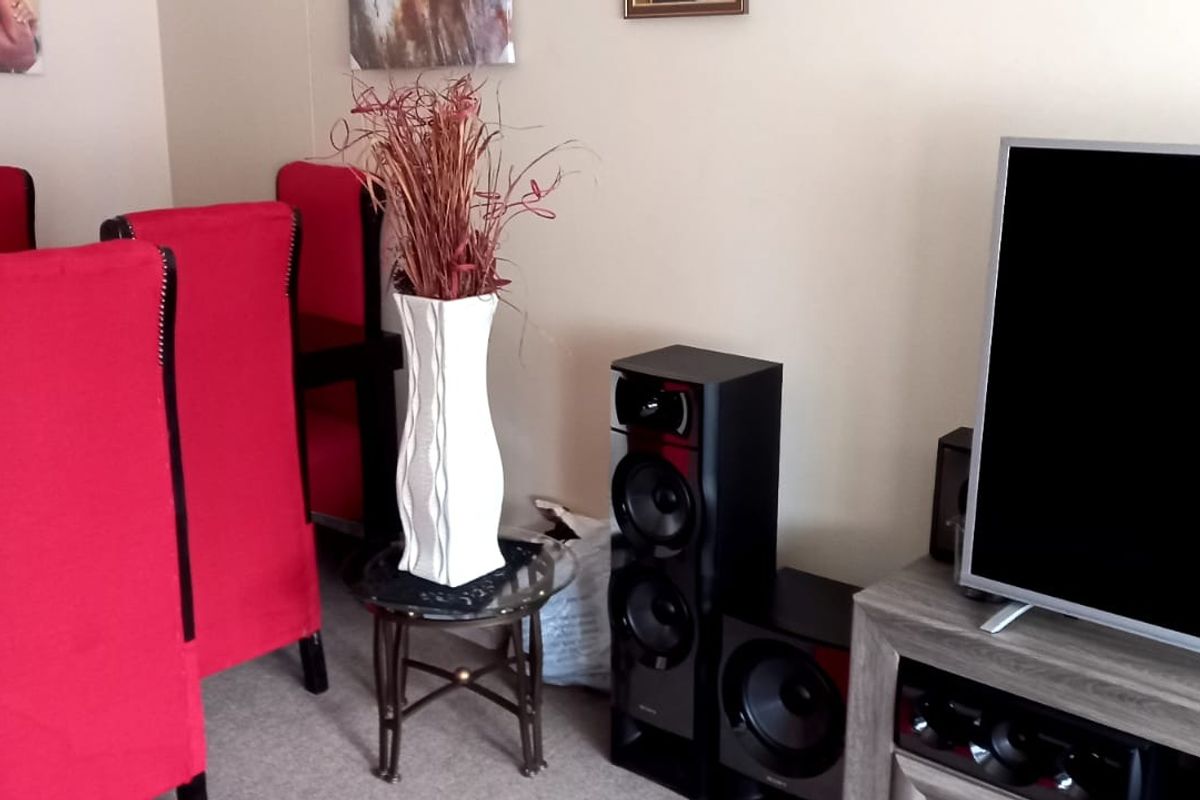 A view of a living area featuring neutral wall finishes and carpeted flooring.