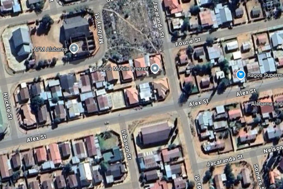 An aerial view of a residential neighborhood showing the street layout and surrounding properties.