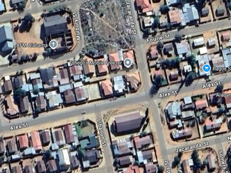 An aerial view of a residential neighborhood showing the street layout and surrounding properties.