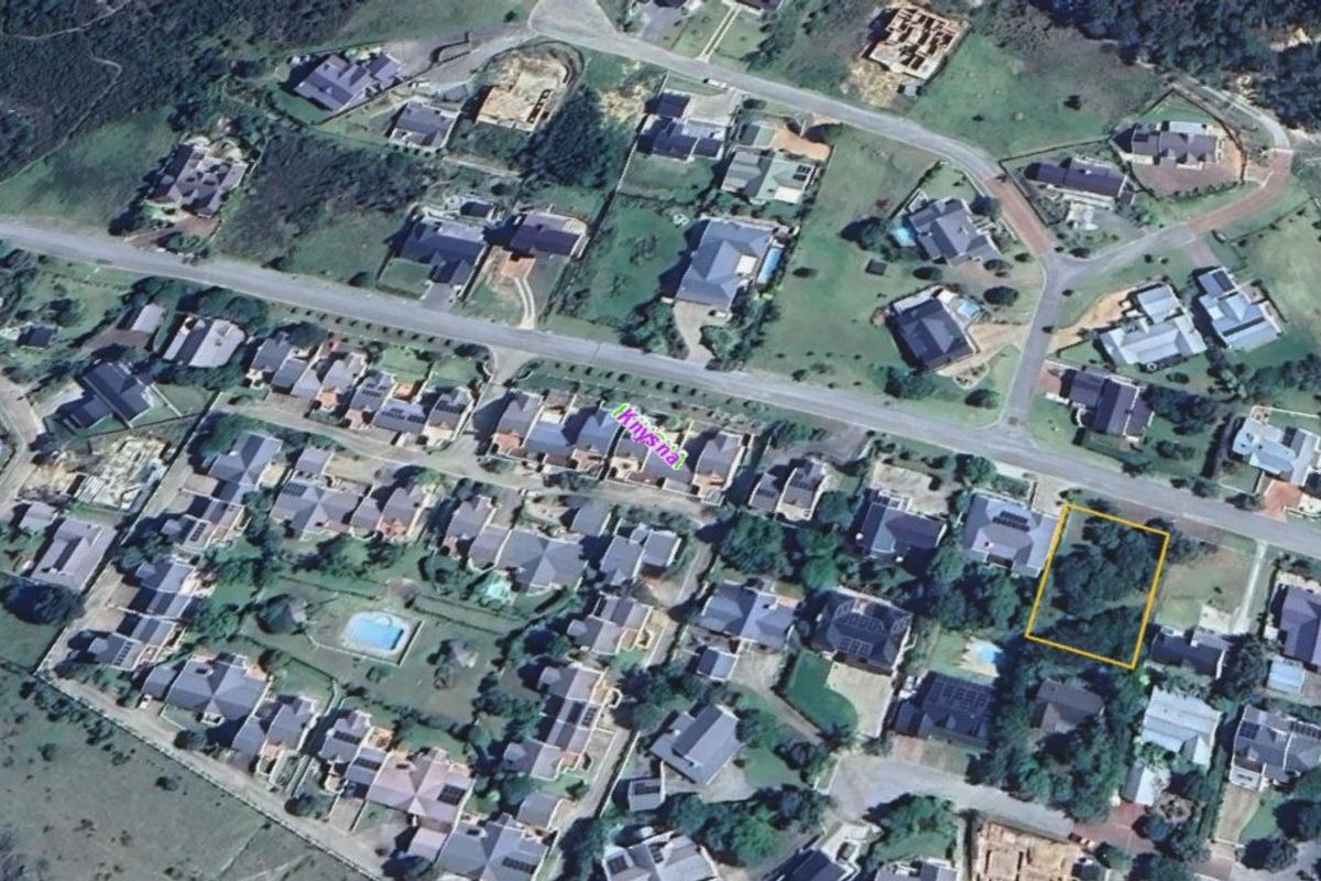 Aerial view of a residential estate highlighting a vacant land plot outlined in yellow, situated within a developed neighborhood.