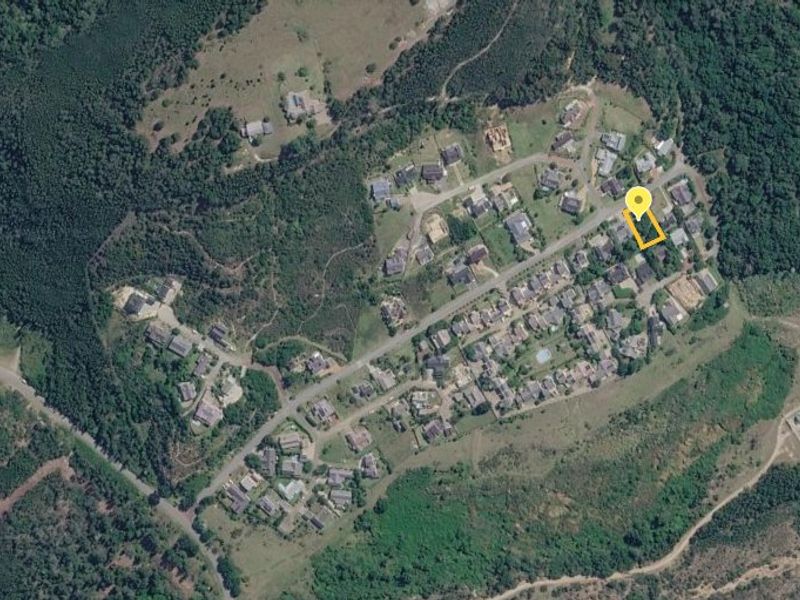 Aerial view of the residential plot located within a developed estate, showing the surrounding neighborhood and landscape.