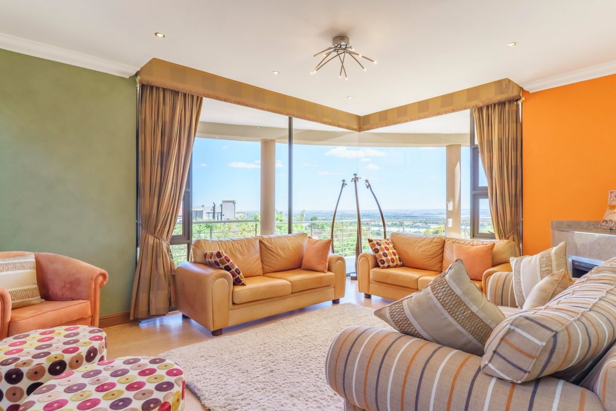 Spacious living area featuring large floor-to-ceiling windows with panoramic views and access to an outdoor balcony.