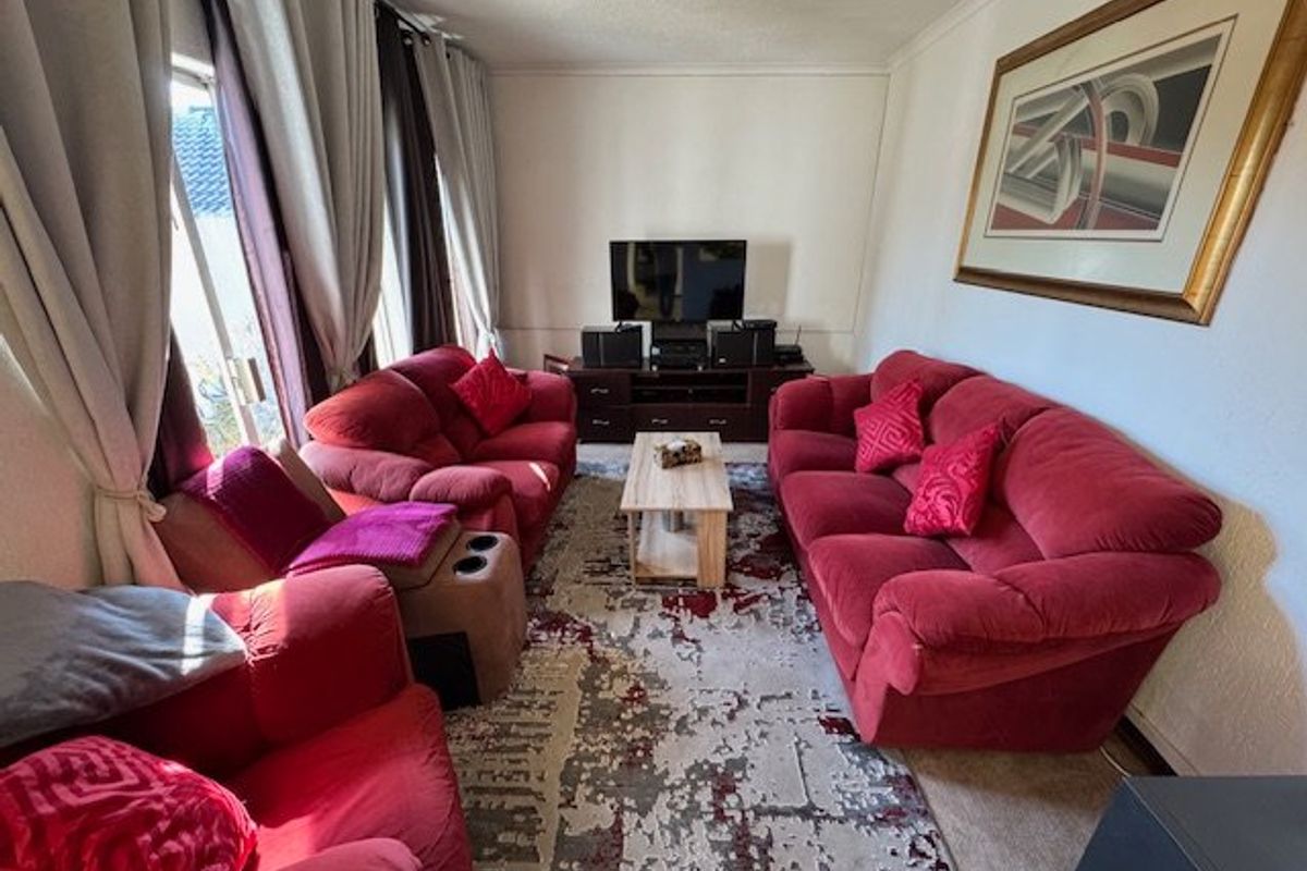 A comfortable living room featuring a sliding glass door that provides natural light and access to the exterior.