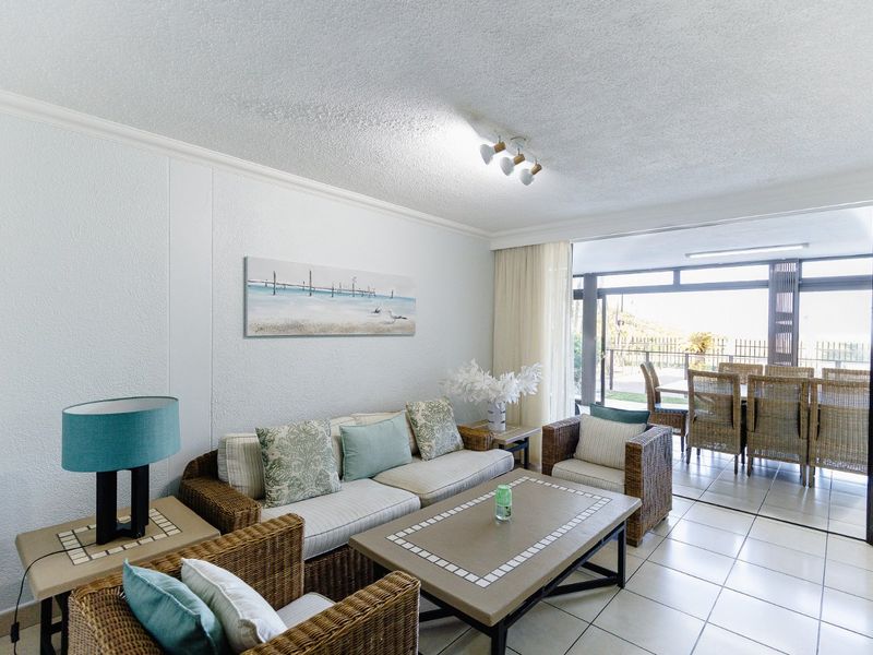Open plan living area featuring tiled flooring and large sliding glass doors providing seamless access to the outdoor patio space.