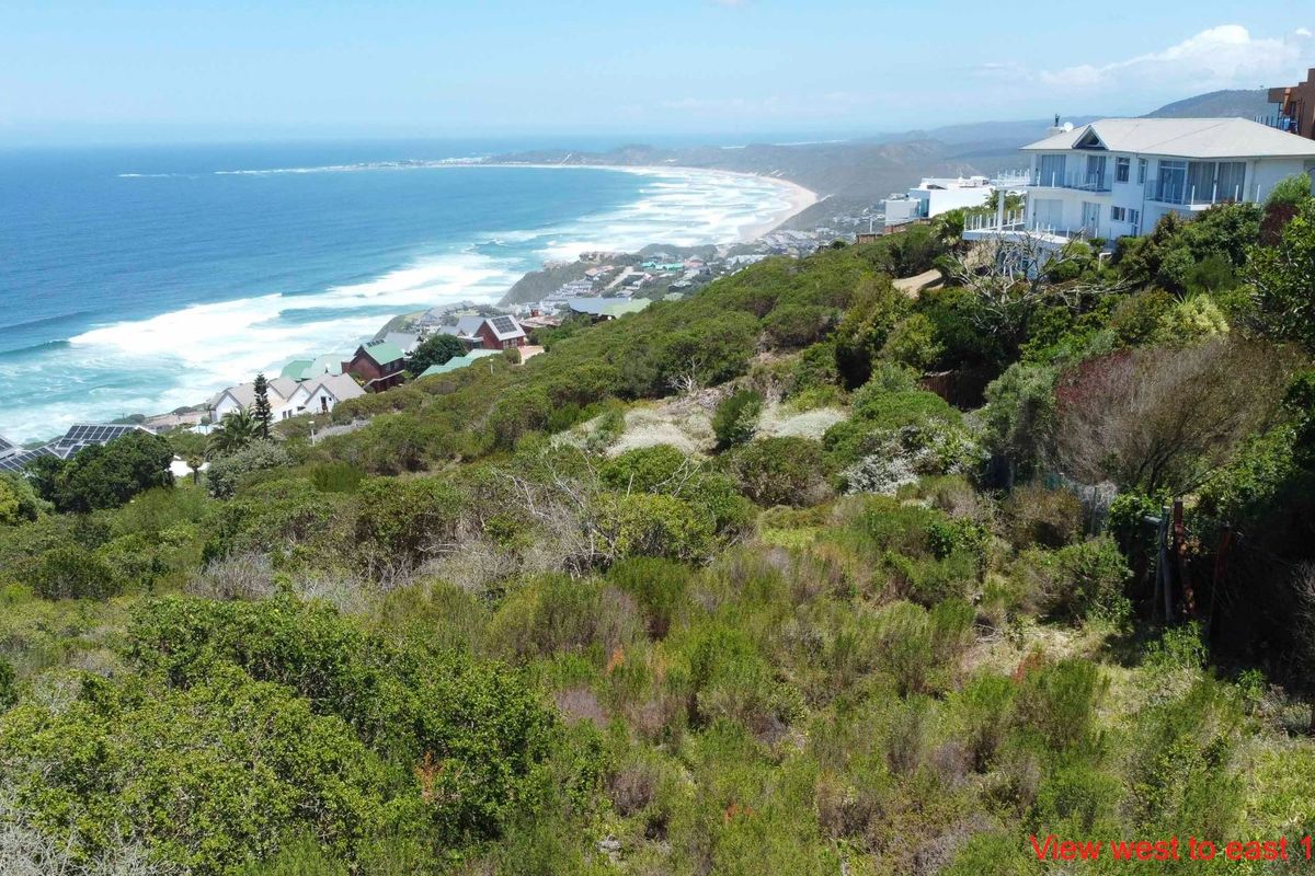 Elevated coastal view overlooking the ocean and surrounding residential landscape from the vacant residential plot.