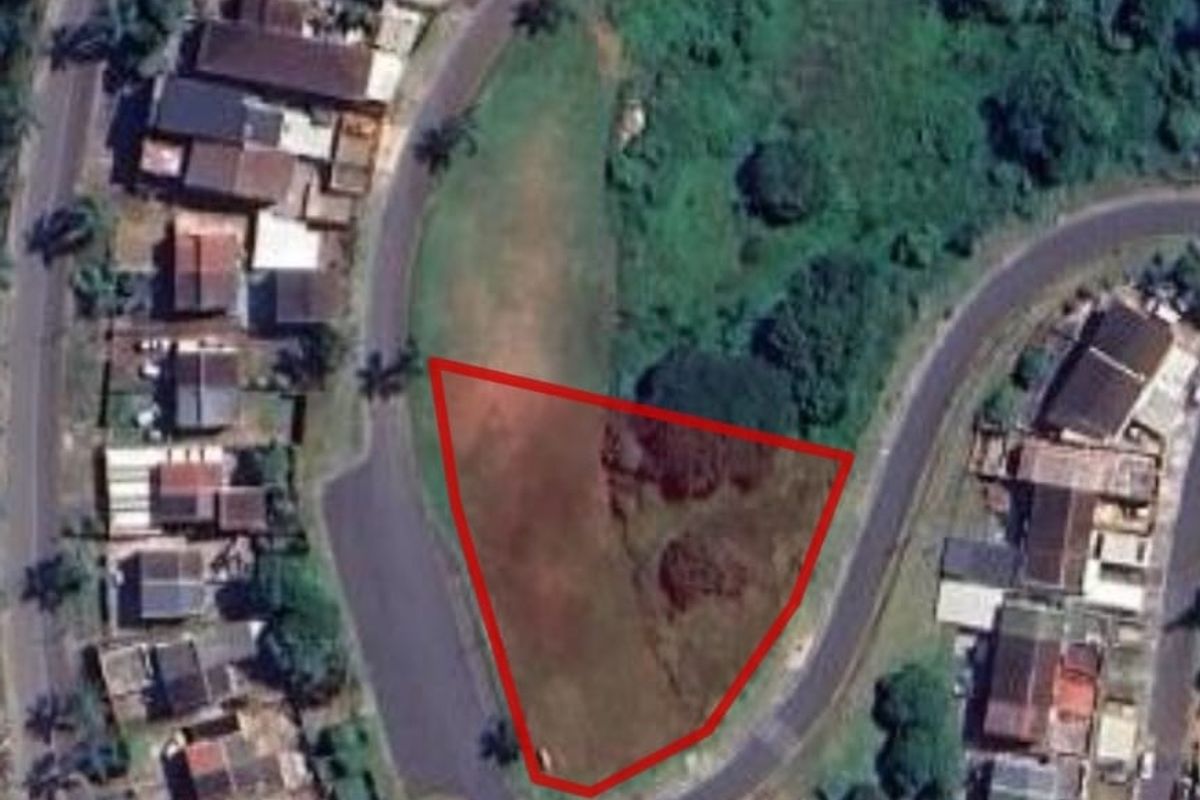 Aerial view of a vacant residential plot with red boundary lines indicating the property perimeter.