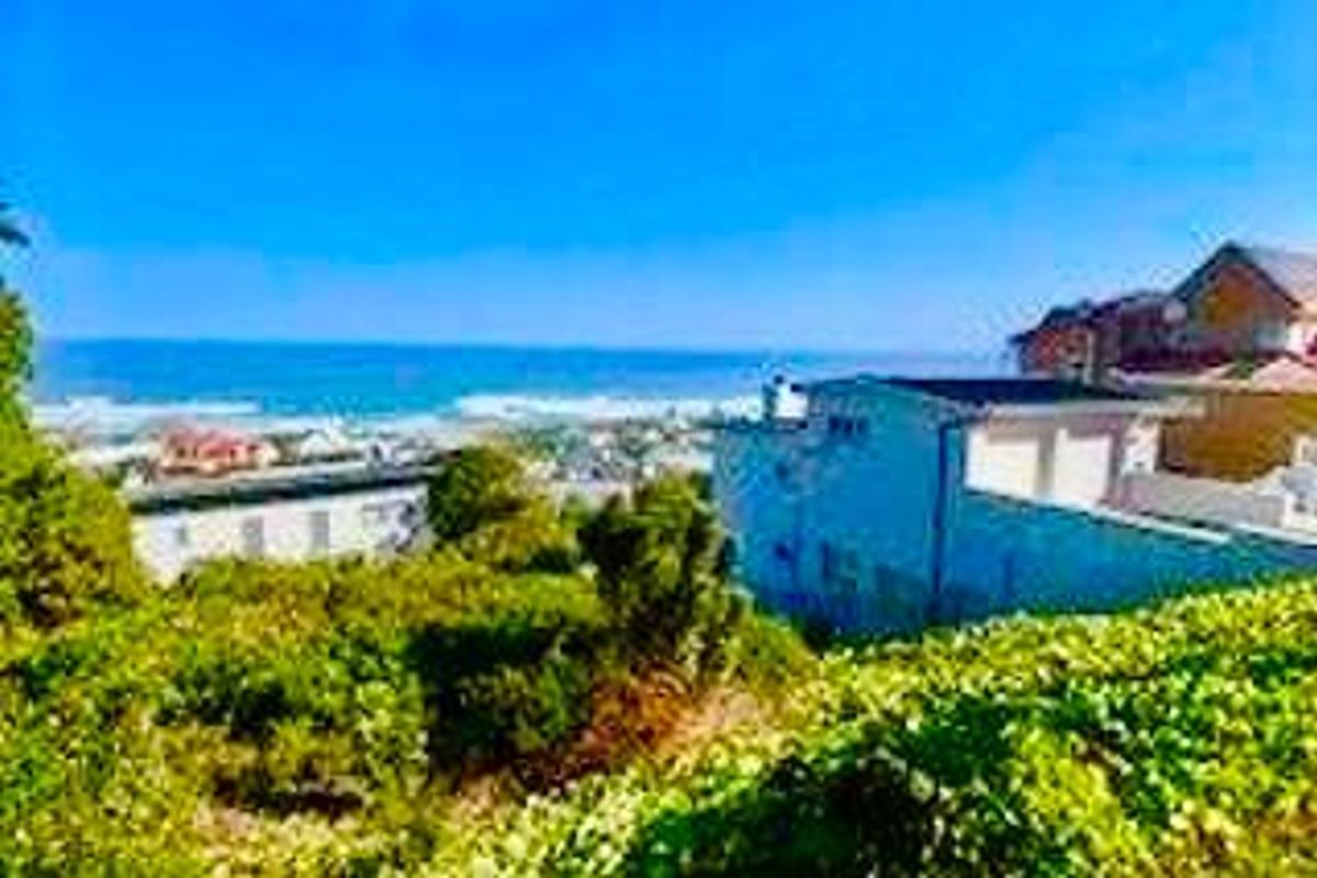 A scenic elevated view overlooking the coastline and ocean, showcasing the property's prime location and surrounding landscape.