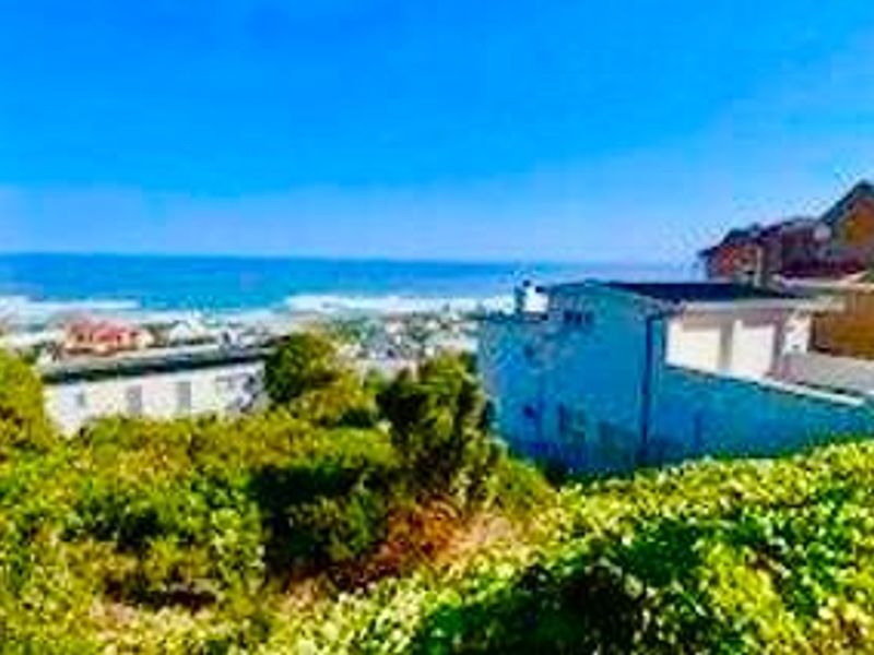 A scenic elevated view overlooking the coastline and ocean, showcasing the property's prime location and surrounding landscape.