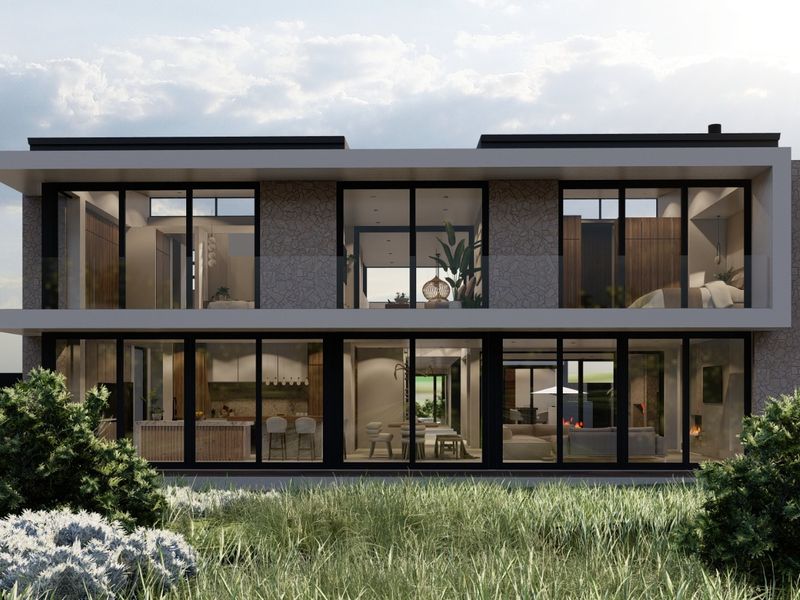 A modern two-story residential facade featuring extensive floor-to-ceiling glass, stone cladding, and a sleek flat roof design overlooking a natural landscape.