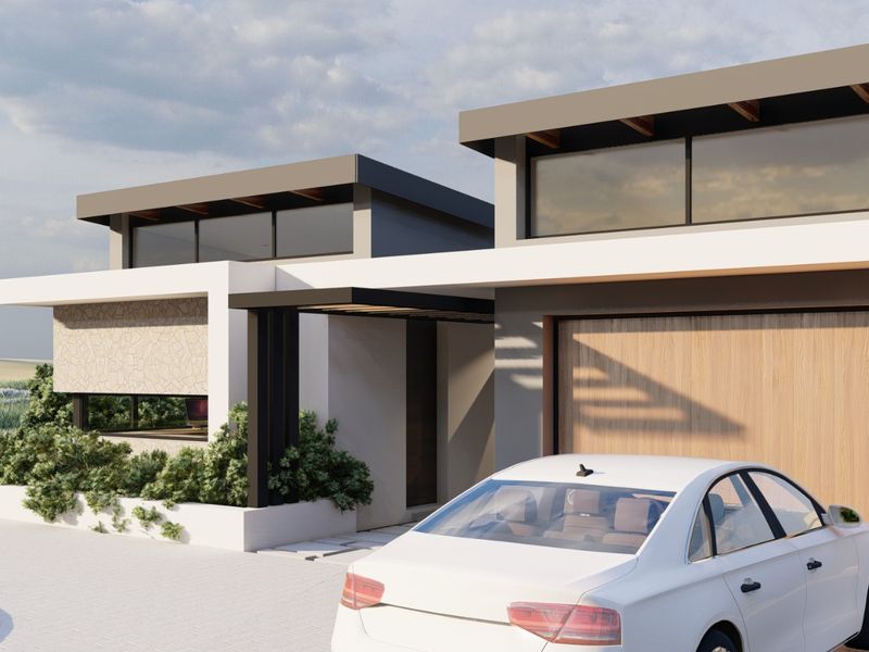 A modern residential facade featuring clean lines, flat roof architecture, stone accents, and an integrated garage.