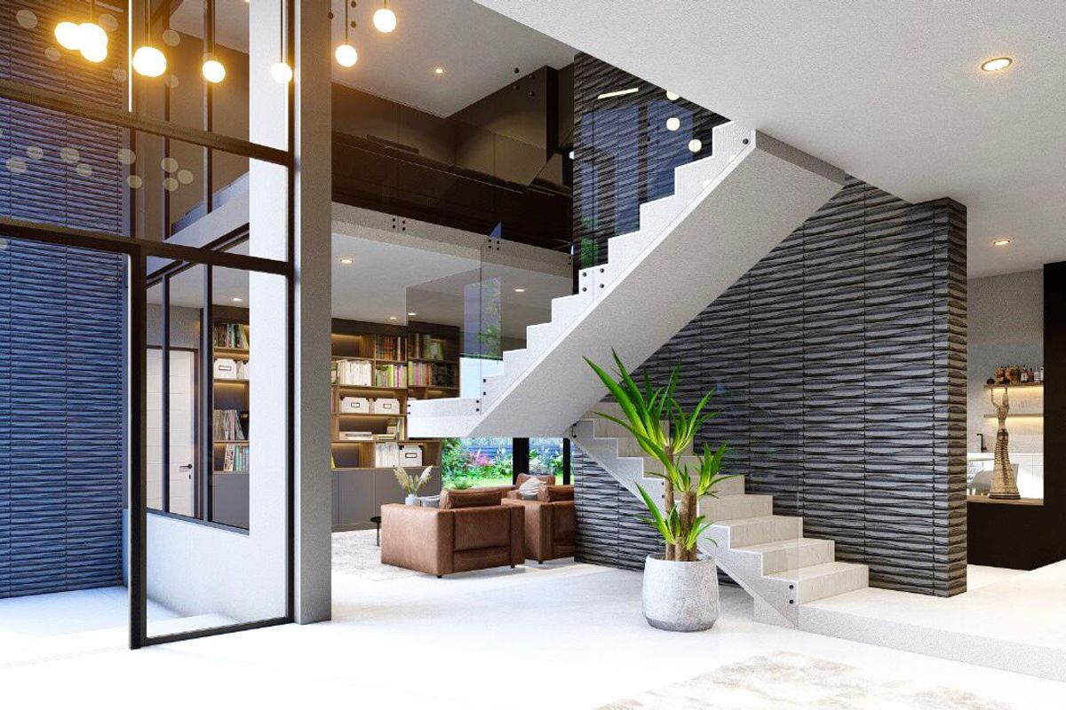 Modern open-plan living area featuring a striking floating staircase with glass balustrade, textured feature walls, and extensive built-in shelving.
