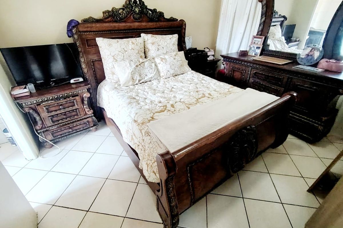 A bedroom featuring ceramic floor tiles, providing a neutral base for the space.