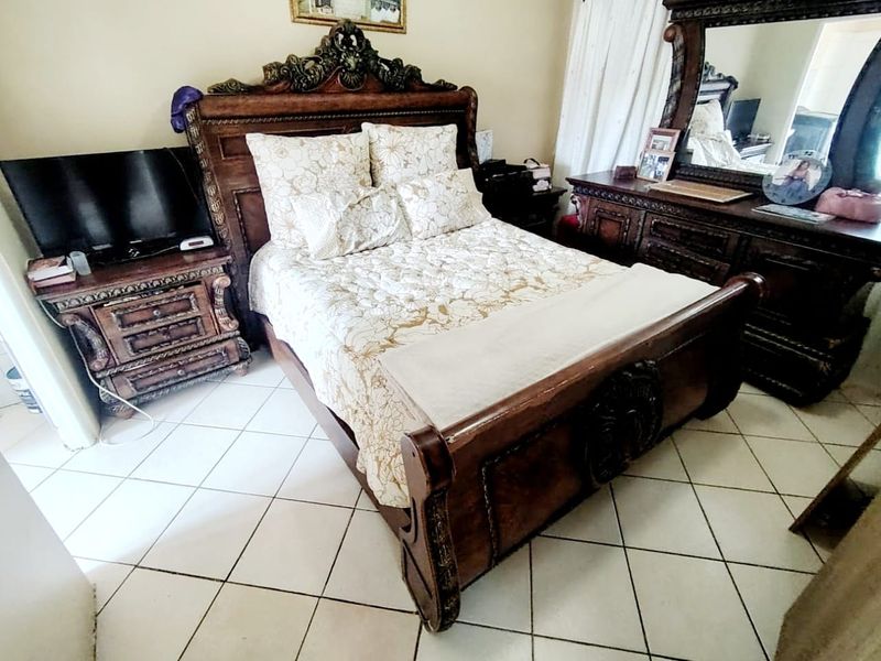 A bedroom featuring ceramic floor tiles, providing a neutral base for the space.