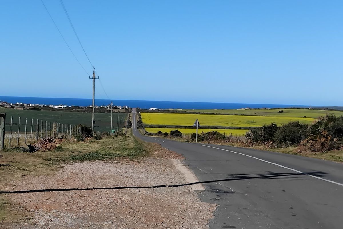 A view of the approach road leading towards the coast, featuring surrounding rural landscape and open fields.