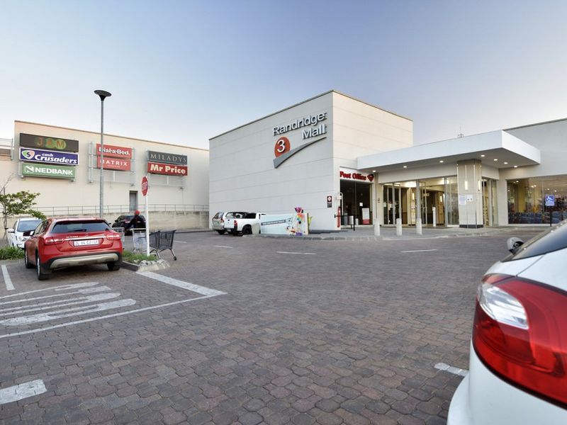 Front exterior view of Randridge Mall featuring a paved parking area, commercial signage, and a covered entrance canopy.