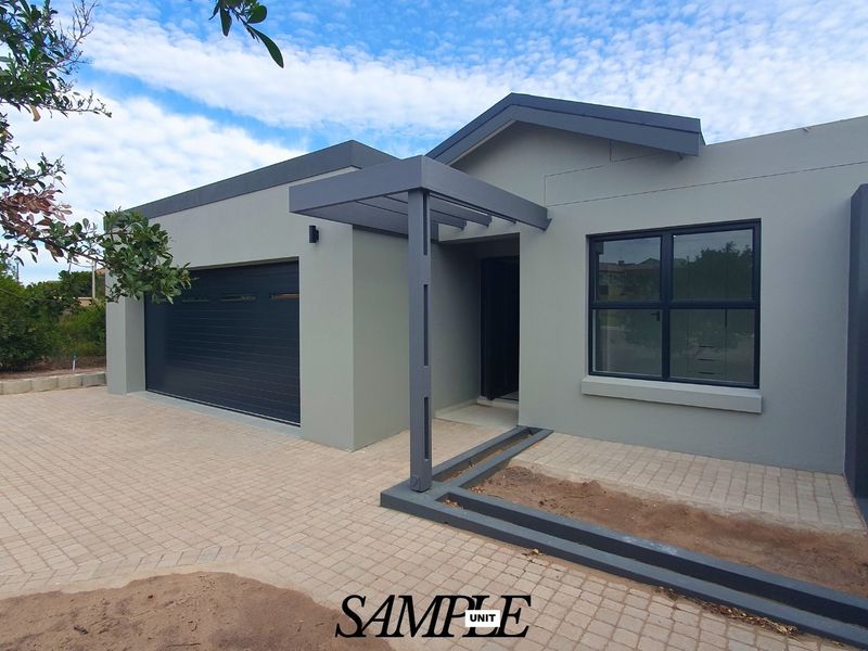 Modern front elevation featuring a paved driveway, single garage, and a covered entrance with contemporary grey finishes.