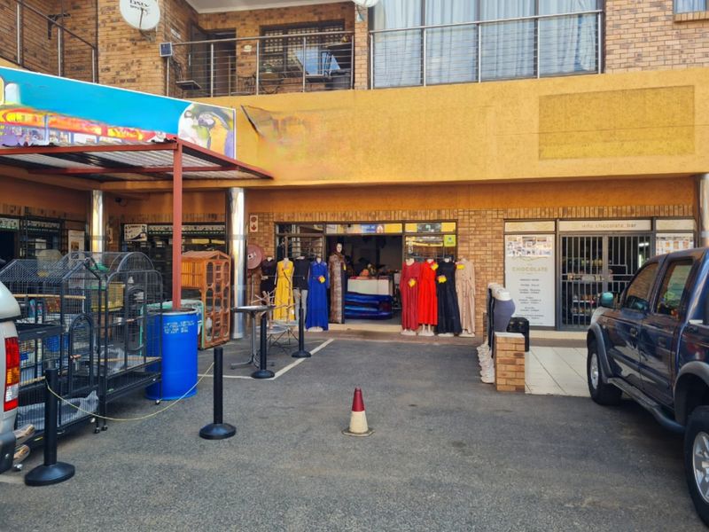 Commercial storefront featuring a brick facade, glass entrance, and covered walkway area, suitable for retail or service-based business operations.