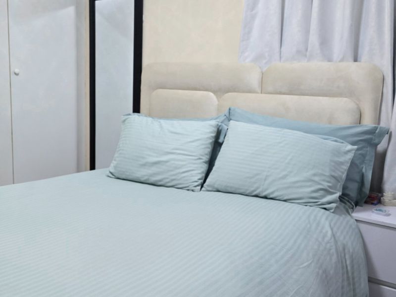 A well-maintained bedroom featuring a built-in wardrobe and neutral finishes, providing a comfortable and functional sleeping space.
