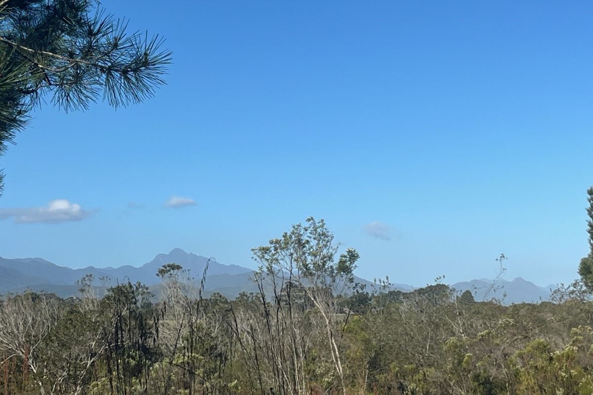 A scenic view of the surrounding natural landscape and distant mountain range, showcasing the property's tranquil and elevated outlook.