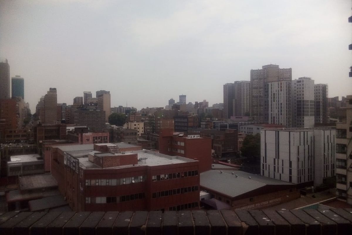 An elevated urban cityscape view overlooking surrounding buildings and infrastructure.