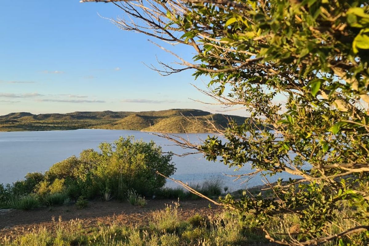 Scenic elevated view overlooking a large dam and surrounding natural landscape.