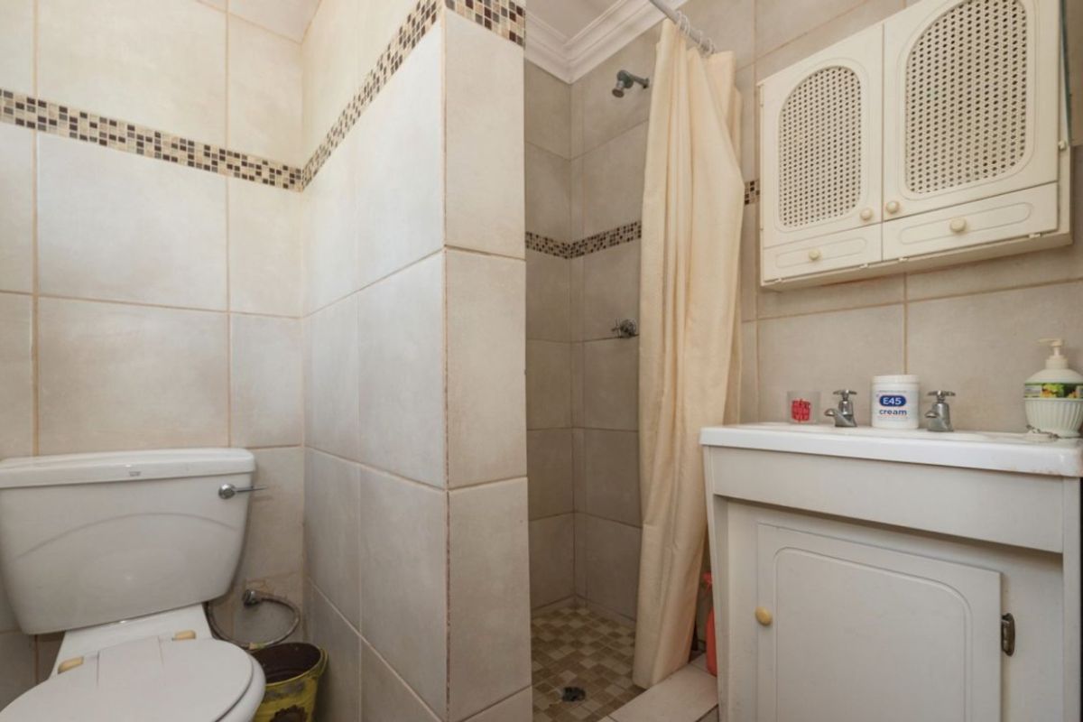 1 Bed Simplex – Secure and Pet-Friendly Starter Home  This neat 1-bedroom simplex offers a great opportunity for first-time buyers or investors. With 39 m2 of living space, the unit includes an open-plan lounge and a functional kitchen with wooden counter tops. The bathroom is compact and convenient, and one covered carport is included.  The unit is pet-friendly and features good security with Spanish bars on the windows and a security gate. The complex offers added peace of mind with armed response, a panic button system, remote-controlled access, and an intercom.  Affordable, secure, and well-located—don’t miss out! Contact us today to arrange a viewing. - Photo 5