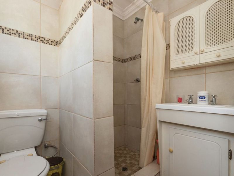 1 Bed Simplex – Secure and Pet-Friendly Starter Home  This neat 1-bedroom simplex offers a great opportunity for first-time buyers or investors. With 39 m2 of living space, the unit includes an open-plan lounge and a functional kitchen with wooden counter tops. The bathroom is compact and convenient, and one covered carport is included.  The unit is pet-friendly and features good security with Spanish bars on the windows and a security gate. The complex offers added peace of mind with armed response, a panic button system, remote-controlled access, and an intercom.  Affordable, secure, and well-located—don’t miss out! Contact us today to arrange a viewing. - Photo 5