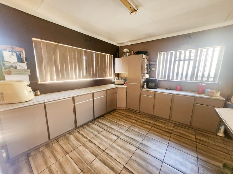 A spacious 4-bedroom family home with 3 bathrooms, multiple living areas, an enclosed lapa, and a sparkling swimming pool—perfect for comfortable family living and entertaining. - Photo 10