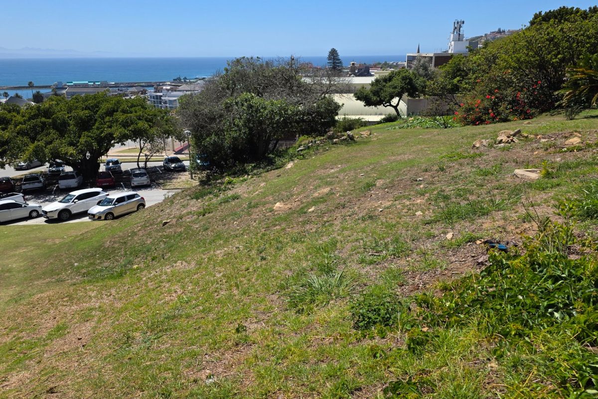 A view of the sloped residential land overlooking the coastal area and nearby parking facilities.