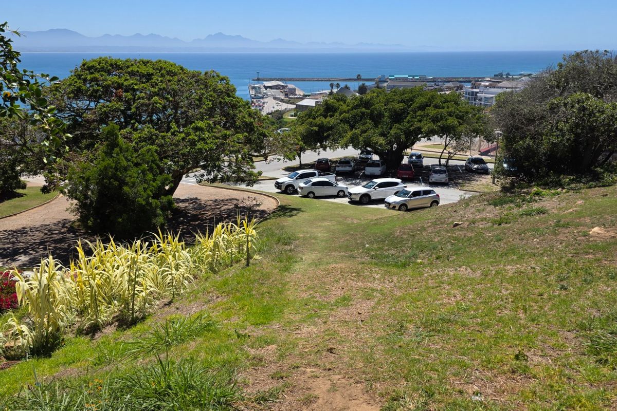 A scenic elevated view overlooking the coastline, harbour, and surrounding landscape, showcasing the property's prime position and natural surroundings.