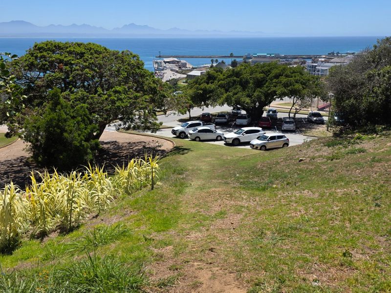 A scenic elevated view overlooking the coastline, harbour, and surrounding landscape, showcasing the property's prime position and natural surroundings.