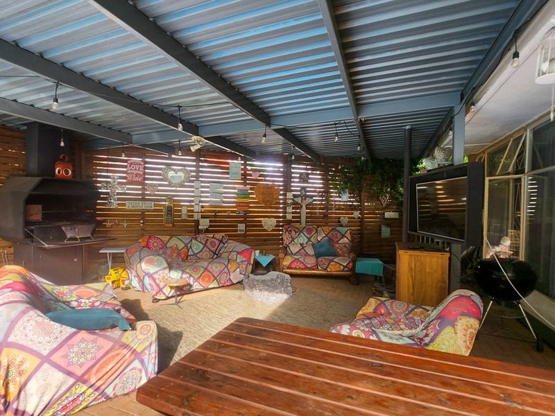 A cozy and inviting 4-bedroom, 3-bathroom family home with a huge scullery, sparkling pool, entertainment area with built-in braai, neat irrigated garden, double garage, and ample parking for all your needs. - Photo 10