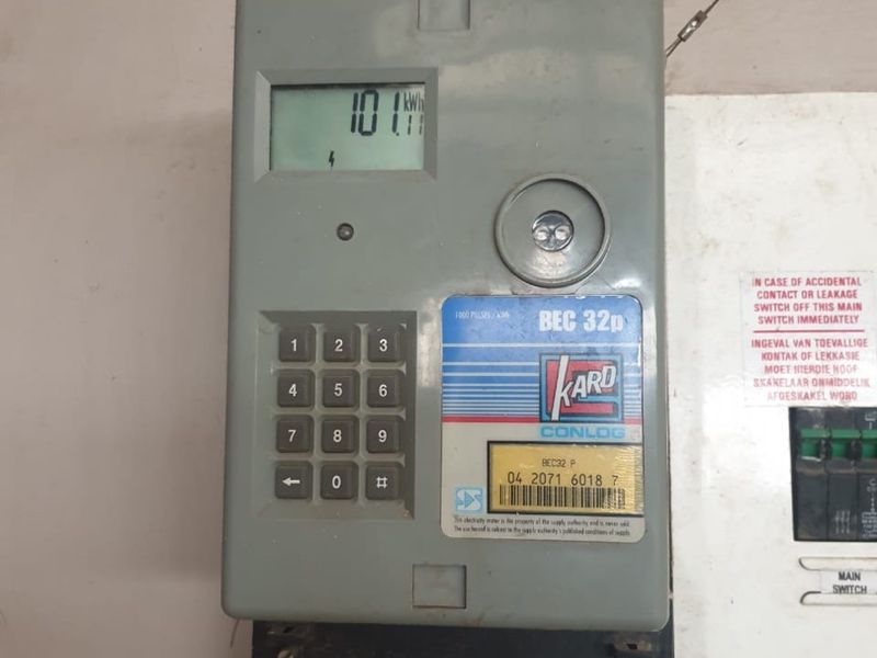 A wall-mounted prepaid electricity meter and electrical distribution board located within the industrial property utility area.