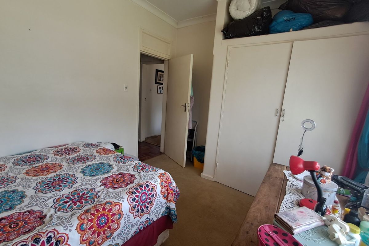 A functional bedroom featuring built-in wardrobe storage, carpeted flooring, and coving detail, offering a neutral base for personalization.