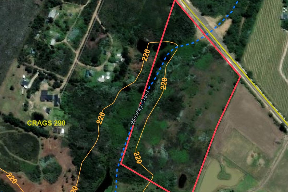 Aerial view of vacant residential land featuring topographical contour lines and proximity to Whiskey Creek.