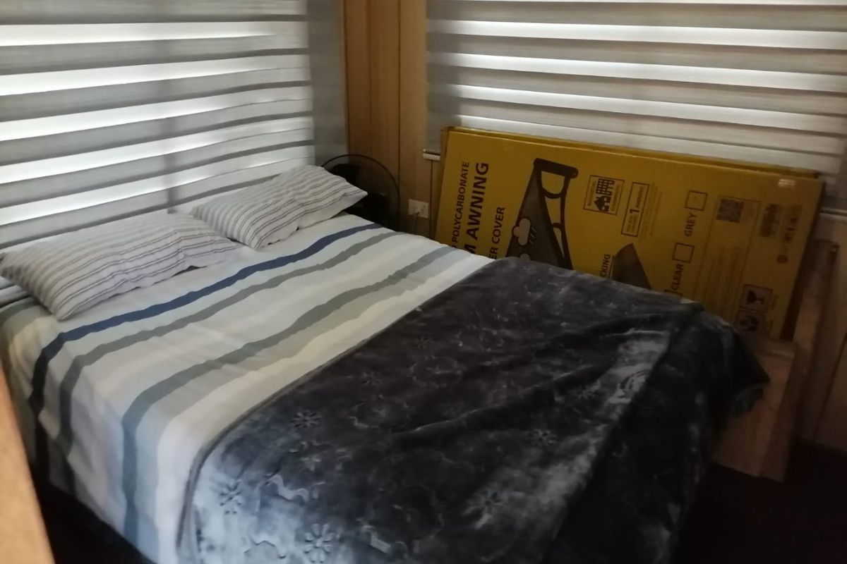 A bedroom featuring modern zebra blinds, providing adjustable light control and privacy.