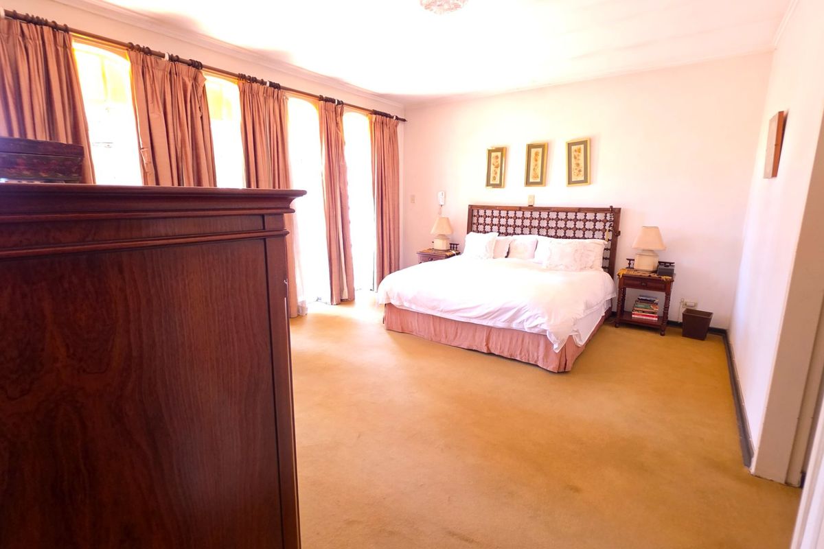 Spacious bedroom featuring wall-to-wall carpeting and large sliding glass doors that provide ample natural light.