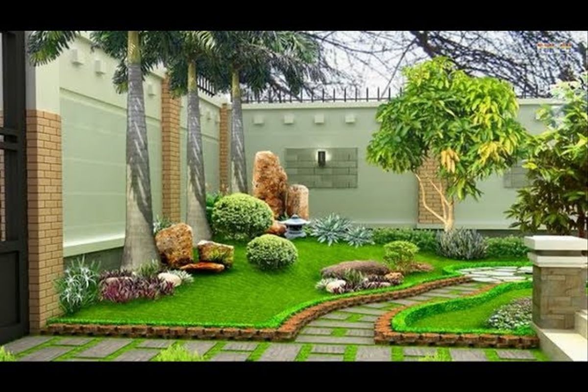 A beautifully landscaped garden featuring a stone pathway, manicured lawn, decorative rock features, and perimeter boundary walls with integrated lighting.