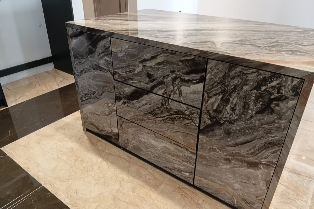 A modern kitchen island featuring high-end marble finishes and integrated cabinetry, set against polished marble flooring.