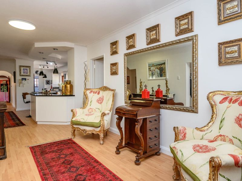 Open plan living area featuring laminate flooring and a kitchen island, providing a functional and connected space for daily living and entertaining.