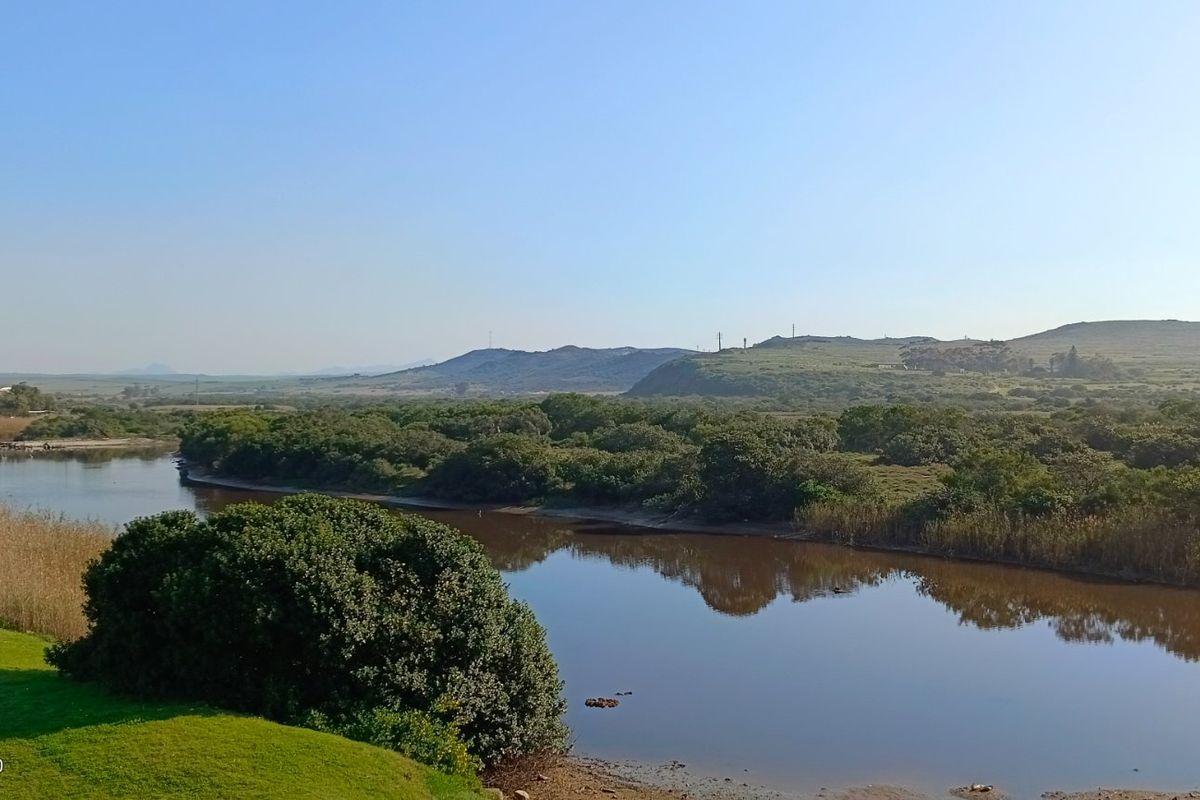 A scenic view overlooking a tranquil river and natural landscape, showcasing the peaceful surroundings of the property.