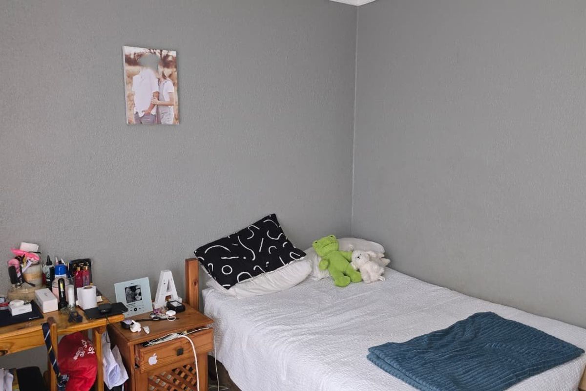 A standard bedroom featuring grey painted walls and neutral flooring, providing a functional and versatile living space.