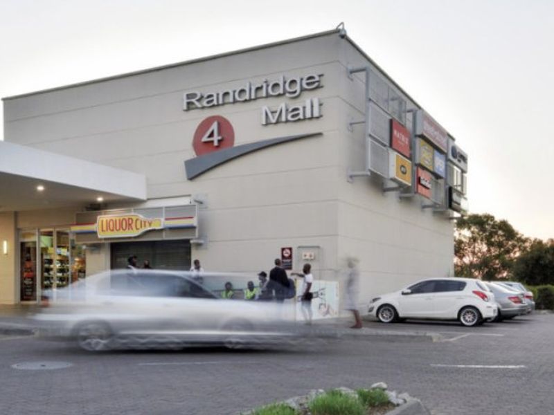 Exterior view of the Randridge Mall entrance featuring commercial signage, a paved parking area, and a covered entrance canopy.