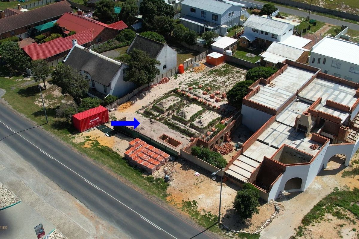 Aerial view of a residential property currently under construction, showing the building footprint, foundation work, and surrounding site layout.