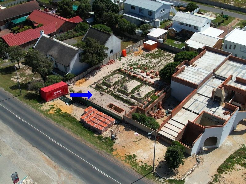 Aerial view of a residential property currently under construction, showing the building footprint, foundation work, and surrounding site layout.