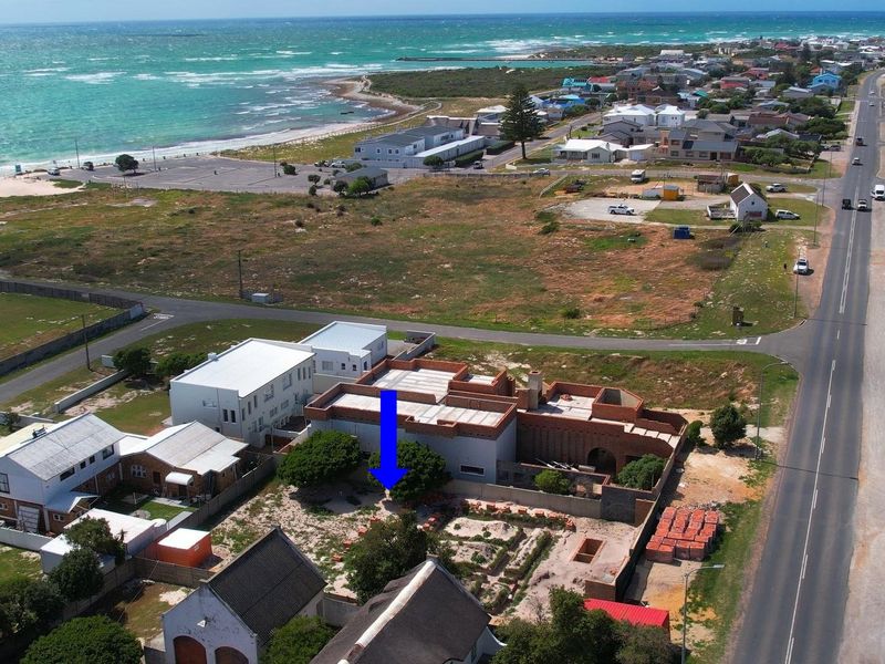 Aerial view of the property location, highlighting its coastal position and proximity to the beach and local infrastructure.