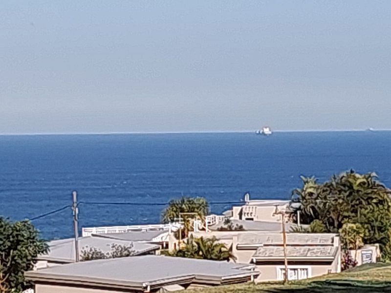 A scenic view overlooking the ocean and surrounding coastal residential properties.