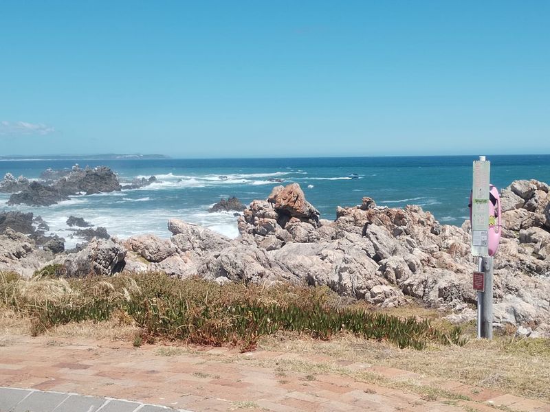 A scenic view of the rocky coastline and ocean, showcasing the natural landscape and coastal environment of the property.